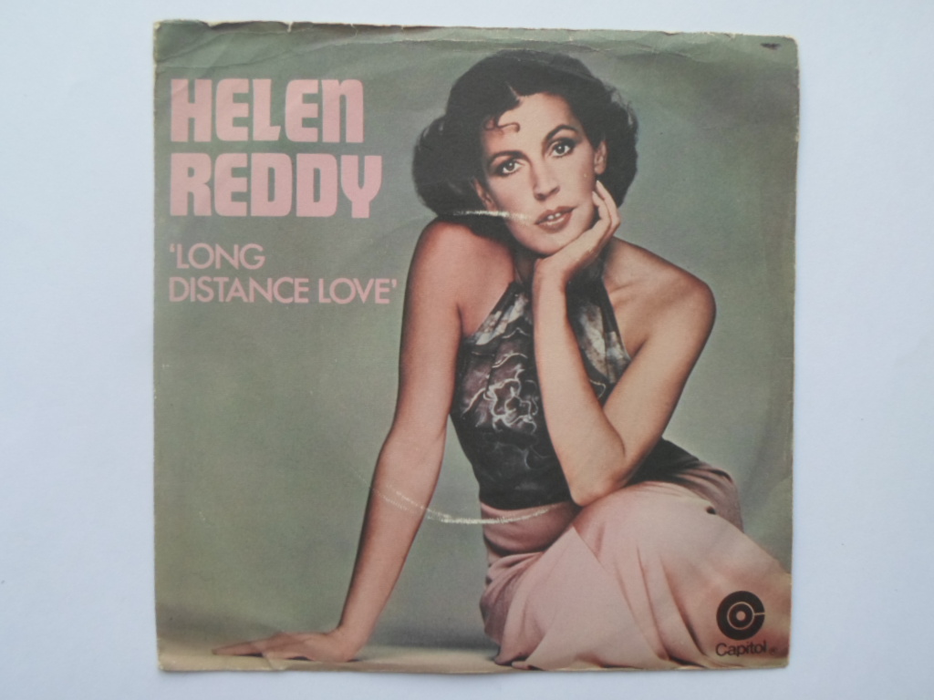 Helen Reddy Long Distance Love 7" Capitol CL15927 EX/VG 1977 picture sleeve, demo. Side one is credited to Hobbs. Side two is credited to Bindi Paoli Sigman. The picture sleeve is quite tatty."