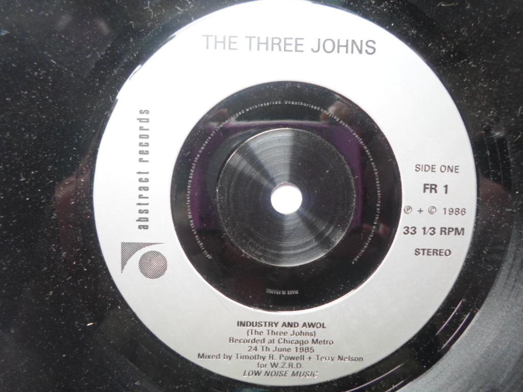 Three Johns Industry And AWOL 7" Abstract FR1 EX 1986 originally came with The World By Storm LP